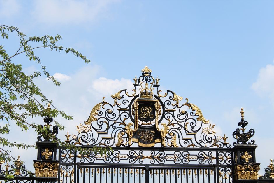 Black metal driveway gate with a pedestrian gate beside it